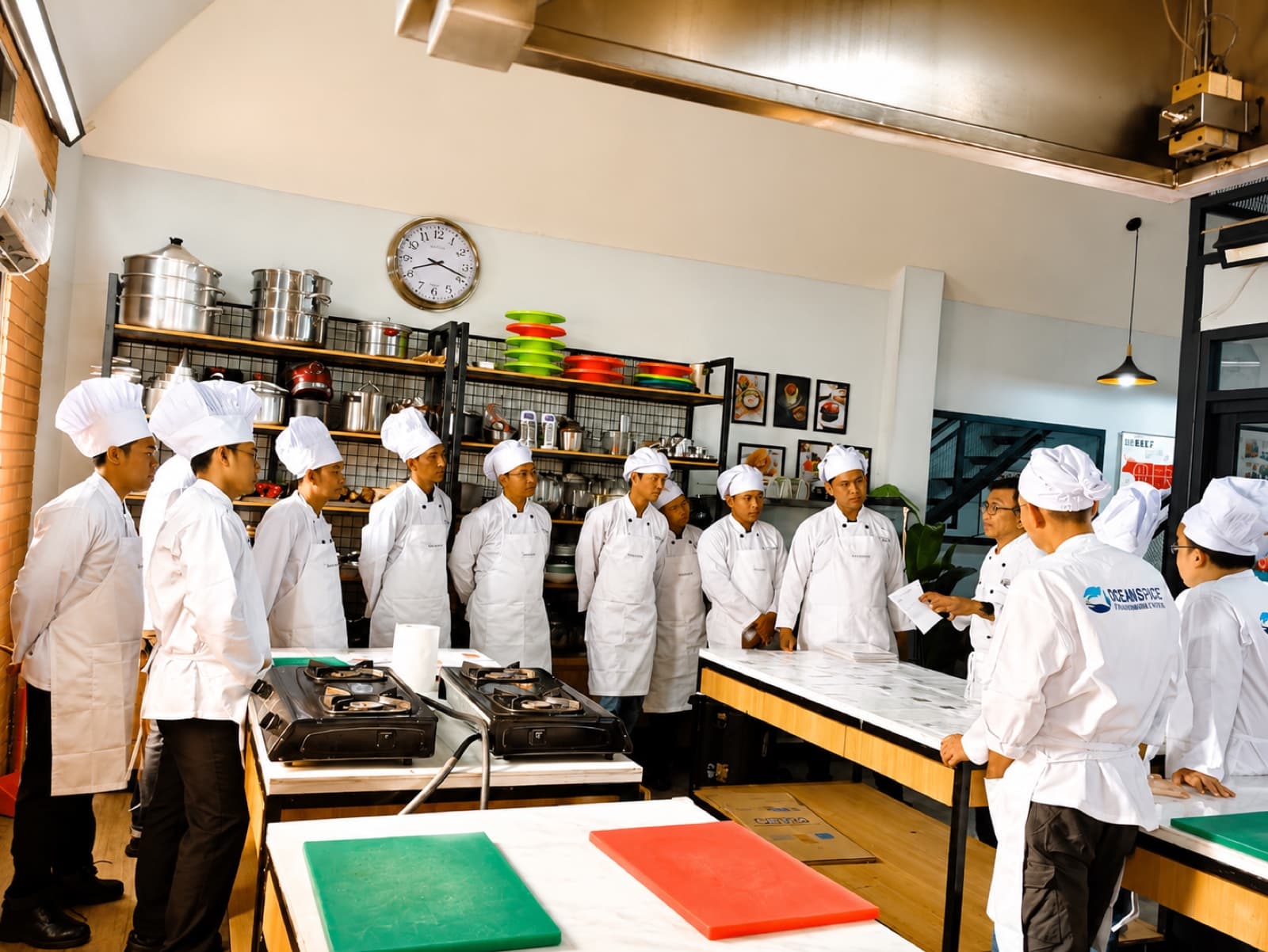 Maritime culinary trainees receiving a professional kitchen briefing
