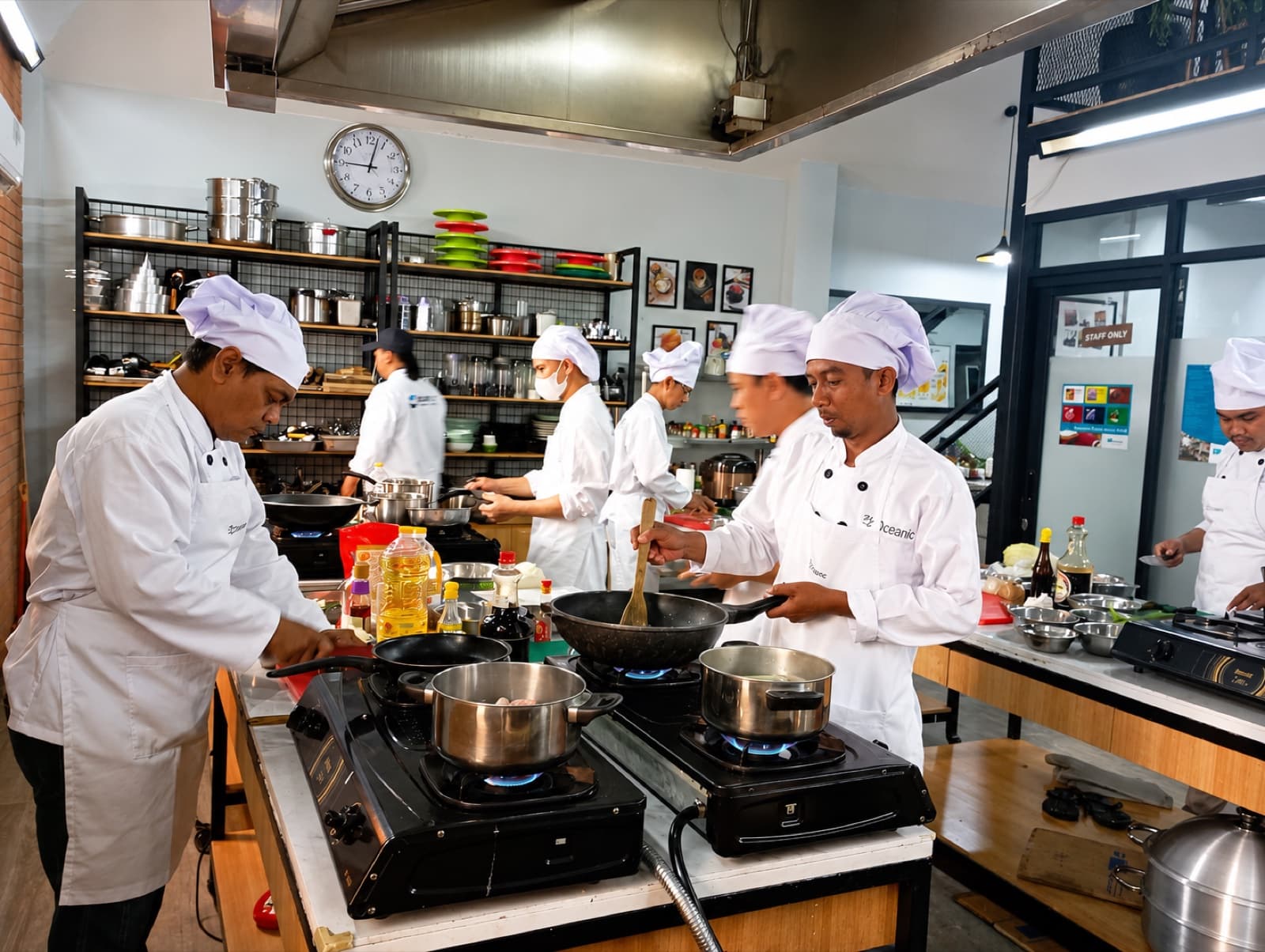 Seafarers developing practical cooking skills under instructor supervision