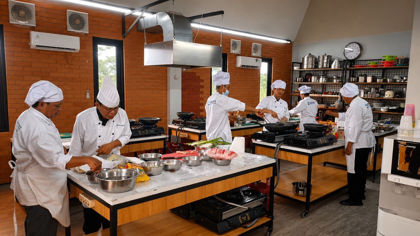 Seafarers completing practical culinary training in a professional kitchen